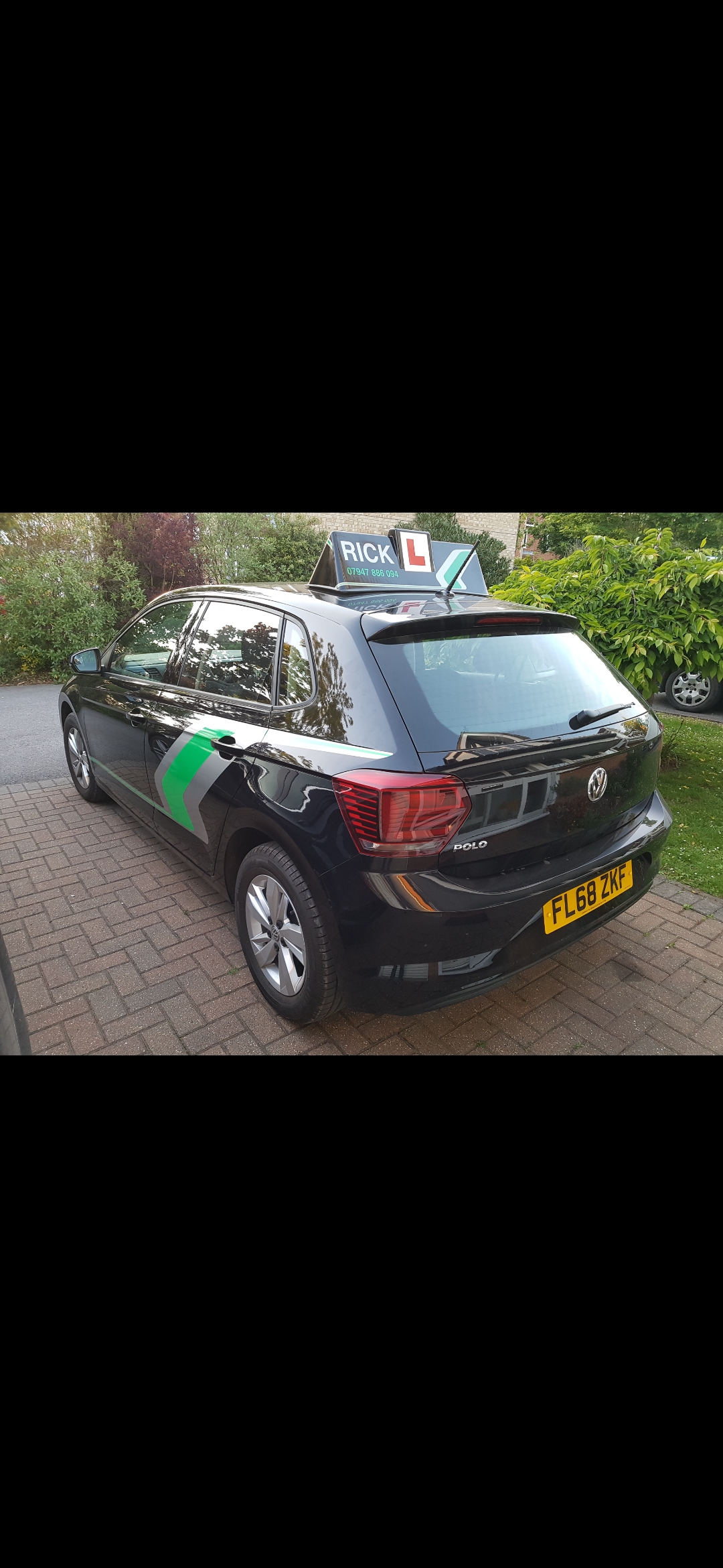 The rear and side of Rick's branded black Volkswagen learner car